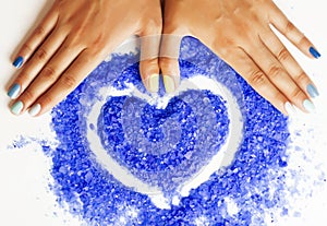 Manicure with blue nails and seasalt close up like heart, love f photo