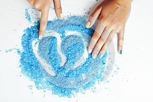 manicure with blue nails and seasalt close up like heart, love for summer photo