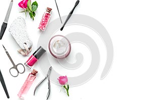 Manicure equipment with nail polish and rose petals white background top view space for text