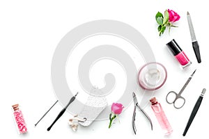 Manicure equipment with nail polish and rose petals white background top view space for text