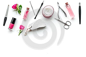Manicure equipment with nail polish and rose petals white background top view space for text