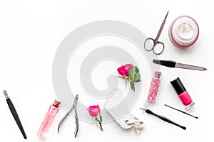 Manicure equipment with nail polish and rose petals white background top view space for text