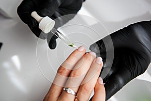 Manicure, Hands spa Cuticle oil. Beautiful Woman hands closeup
