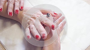 Manicure. Master applies varnish drawing on nails gel in spa . Closeup finger nail care by specialist in beauty salon.