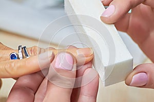 Manicure nail buffering close up.