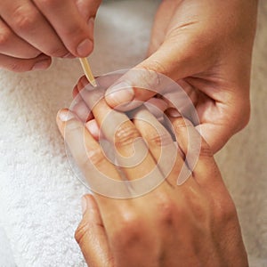 Manicure, nail care and treatment at salon, spa and technician for relaxation. Close up, woman hands or wellness for