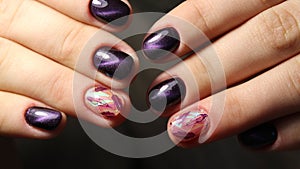 Manicure nail design cat`s eye, feathers on broken glass