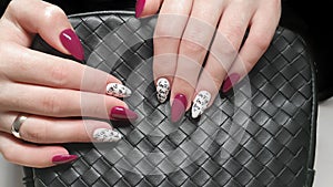 Manicure and nail extension with acrylic and gel. The design is made with reflective gel polishes