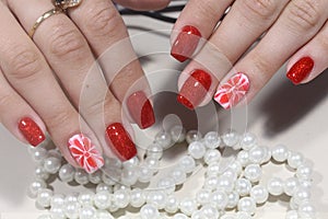 Manicure nails extensively bright red