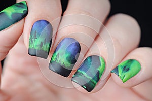 Manicure with northern lights print in blue and green