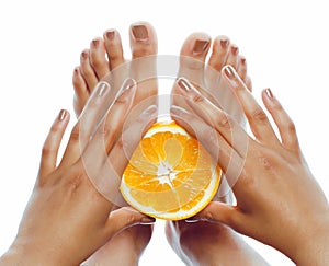 Manicure pedicure on afro-american tann skin hands holding orange, healthcare concept