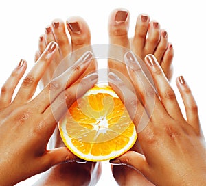 Manicure pedicure on afro-american tann skin hands holding orange, healthcare concept