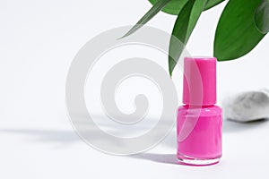 Manicure or pedicure background. Creative mockup of isolated cosmetic bottle with pink nail polish, on white background with hard