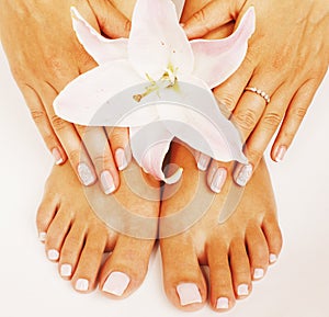 Manicure pedicure with flower lily close up isolated on white perfect shape hands spa salon