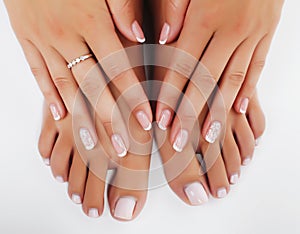 Manicure pedicure with flower lily closeup isolated on white background perfect shape hands spa salon