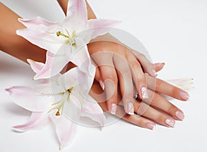 Manicure pedicure with flower lily closeup isolated on white background perfect shape hands spa salon