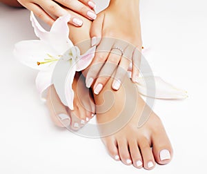 Manicure pedicure with flower lily closeup  on white perfect shape hands spa salon