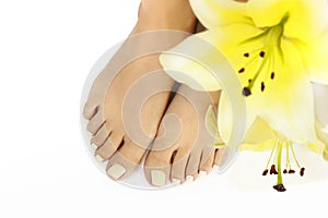 Manicure and pedicure at a long oval shaped nails with yellow lilies