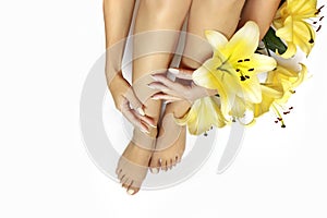 Manicure and pedicure at a long oval shaped nails with yellow lilies