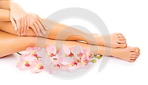 Manicure and pedicure with a pink orchid flower