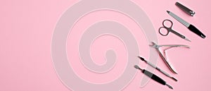 Manicure and pedicure tools on pink background. Top view with copy space. Nail salon banner design template. Beauty treatment and