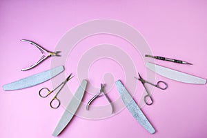 Manicure and pedicure tools on pink background, view from above. Nail salon banner design template. Beauty treatment concept
