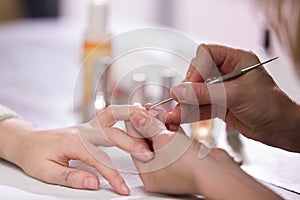 Manicure process. Woman works on younger girl`s hands and nails. Close-up.