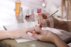 Manicure process. Woman works on younger girl`s hands and nails. Close-up.