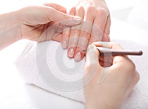 Manicure, pushing skins, a woman to a beautician