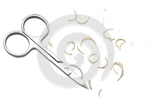 Manicure scissors and nail clipping on white background