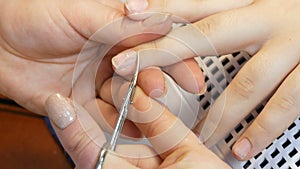 Manicure scissors trim the cuticles on the nails at home