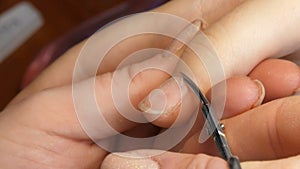 Manicure scissors trim the cuticles on the nails at home