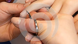 Manicure scissors trim the cuticles on the nails at home