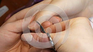 Manicure scissors trim the cuticles on the nails at home