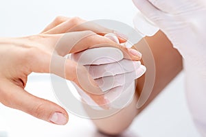 Manicure specialists hands applying glue for nail