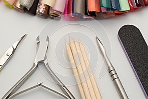 Manicure tools on a white background. Scissors, nail file, sticks, etc photo