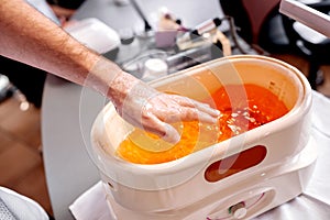 Manicure treatment with applying paraffin wax, nail salon