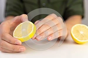 Manicure, woman cleans her nails with lemon.