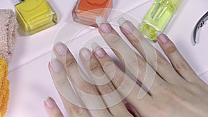 Manicure. Women`s hands with short and long nails. Natural long nails, unpainted. Compare and choose the length of your nails. Cle