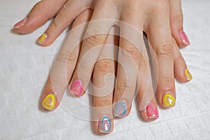 Manicured hands of a beautiful woman. Delicate nails with colorful manicure