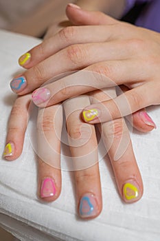 Manicured hands of a beautiful woman. Delicate nails with colorful manicure