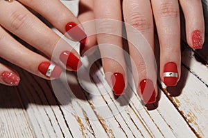 Manicured nails colored with red nail polish