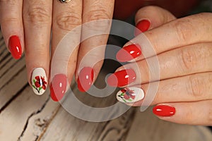 Manicured nails colored with red nail polish