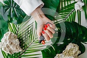 Manicured woman& x27;s nails with red nail polish.