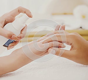 Manicurist Applies Spray to Clients Gentle Hands.