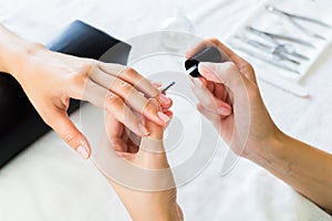 Manicurist applying cuticle softener