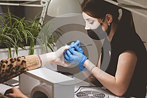 Manicurist cleans cuticles for client