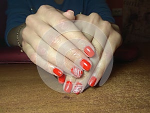 The manicurist excellently made her work a beautiful manicure with a polish gel on her hands and the client is happy