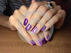 The manicurist excellently made her work a beautiful manicure with a polish gel on her hands and the client is happy