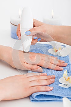 Manicurist Giving Microdermabrasion Therapy On Woman's Hand